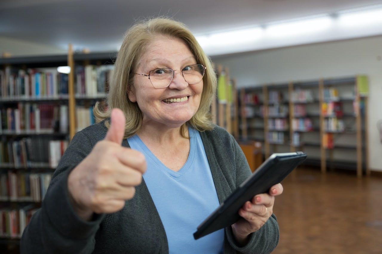 Senior Woman Holding Tablet – Medicare Plan N vs Plan G.jpg